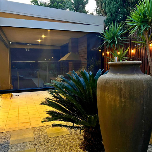 Outdoor Blinds Separating Outdoor Kitchen from Garden